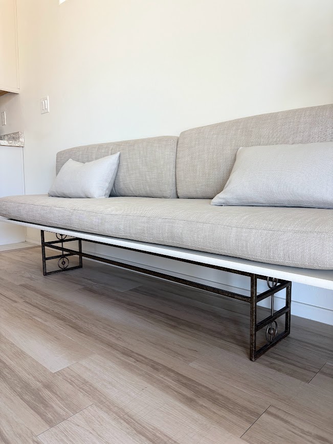 We created a MCM style banquette in a dining area of our Arizona snowbird home from free castoffs and an existing cushion set we owned - Hello Lovely Studio.