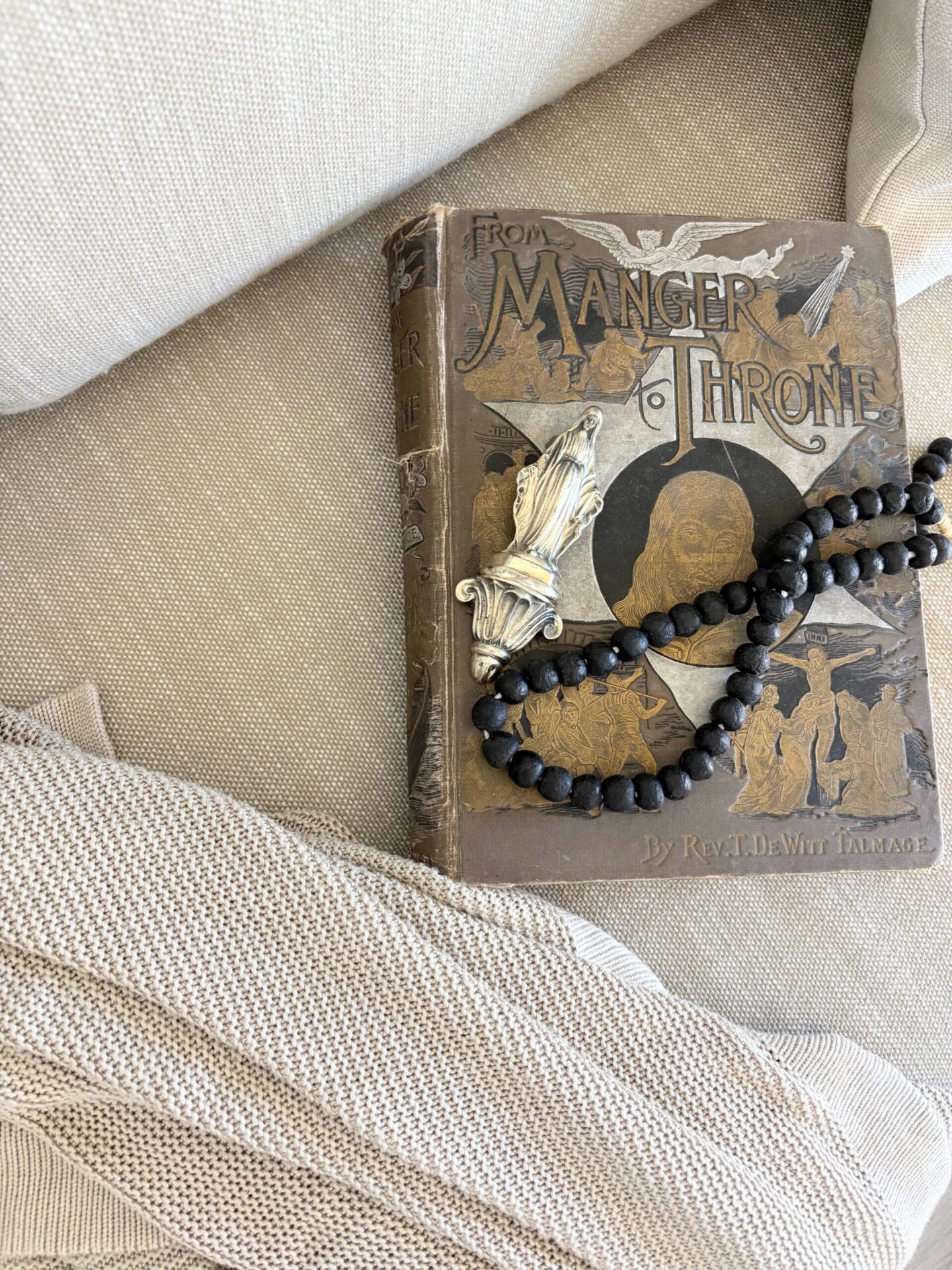 Antique book and African glass beads on a linen cushion - Hello Lovely Studio.