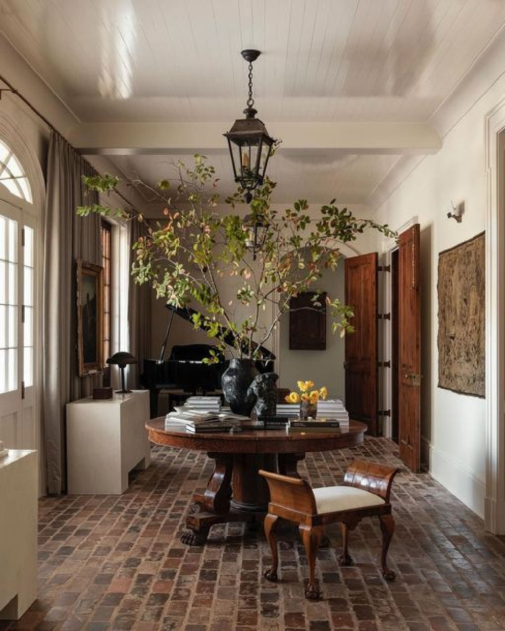 Rustic, timeless, and old world come together in a warm entry designed by Sean Anderson Design.