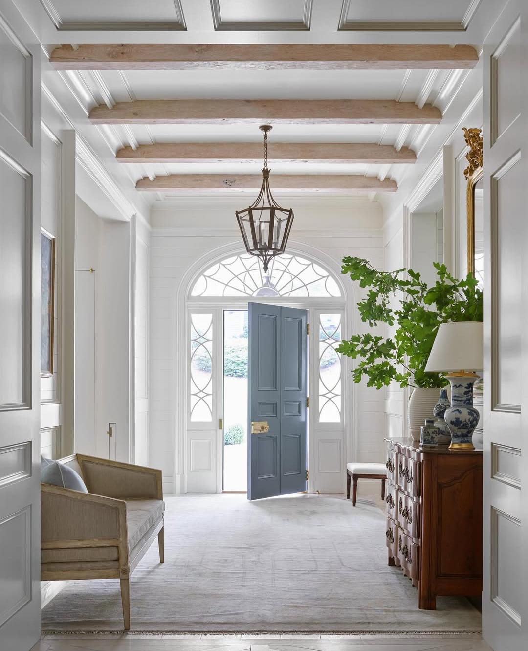 Suzanne Kasler designed entry with wood beams, classic architecture and relaxed elegance - photo: Emily Followill.