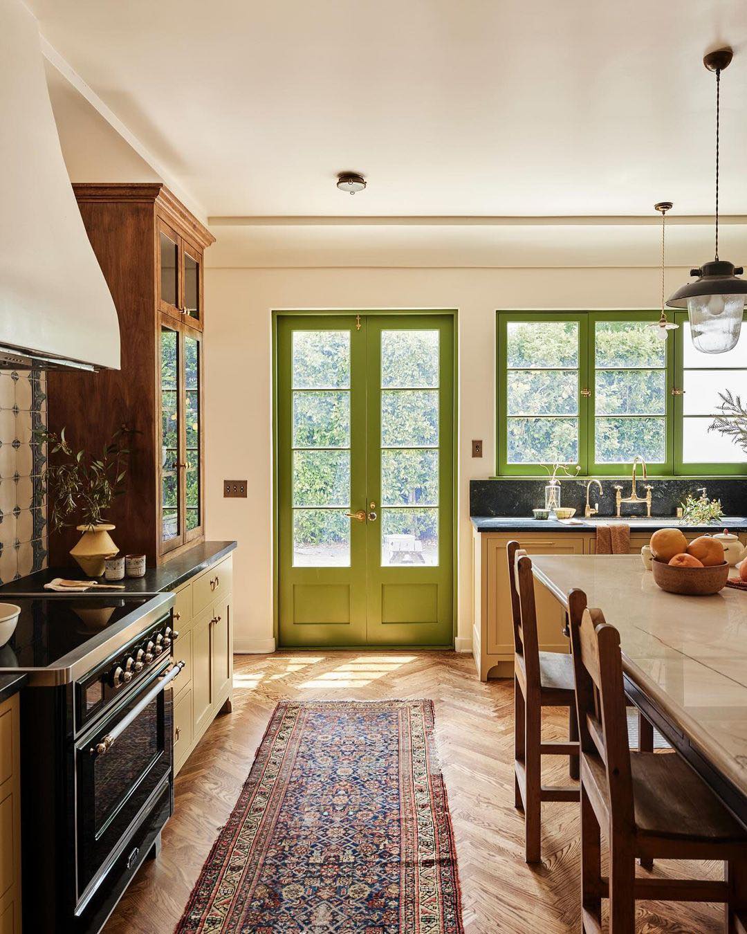 Jamie Haller designed timeless bespoke kitchen with lime green painted French doors and trim.