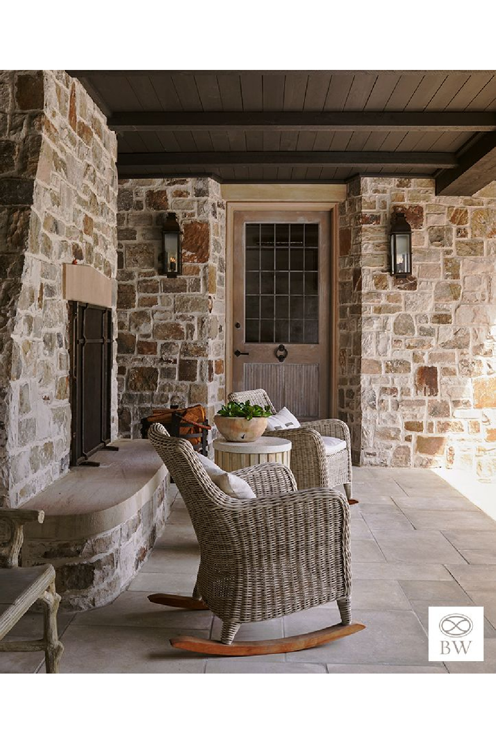 Wicker rocking chairs on overgrouted stone porch with firepit - Beth Webb Interiors (Birmingham project).