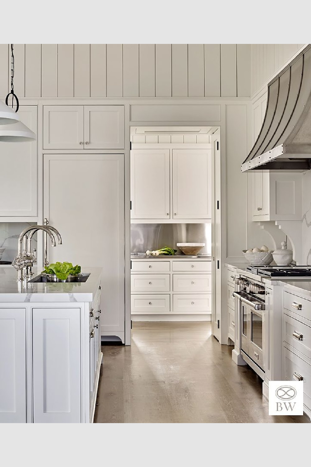 Stainless backsplash, custom corbel details, and dazzling range hood in a classic timeless kitchen design from Beth Webb's Frederica project.