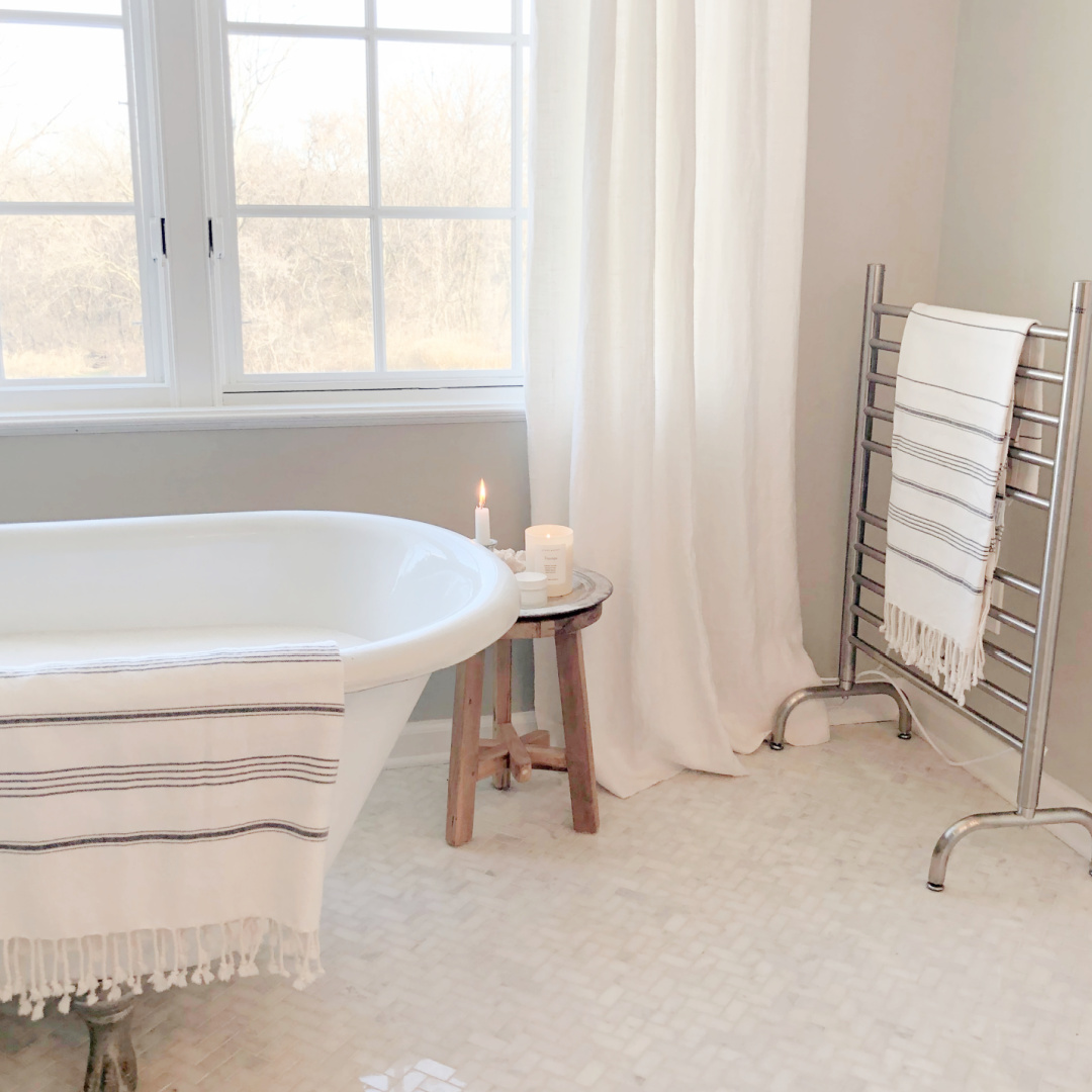 Hello Lovely's renovated bath with clawfoot tub and marble herringbone mosaic tile floor - SW Repose Gray on walls.