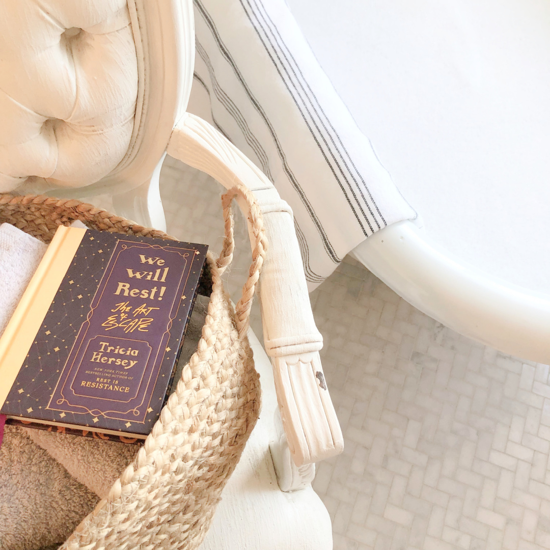 In Hello Lovely's bath "We Will Rest: The Art of Escape" by Tricia Hersey near a bubblebath. #triciahersey #restisresistance