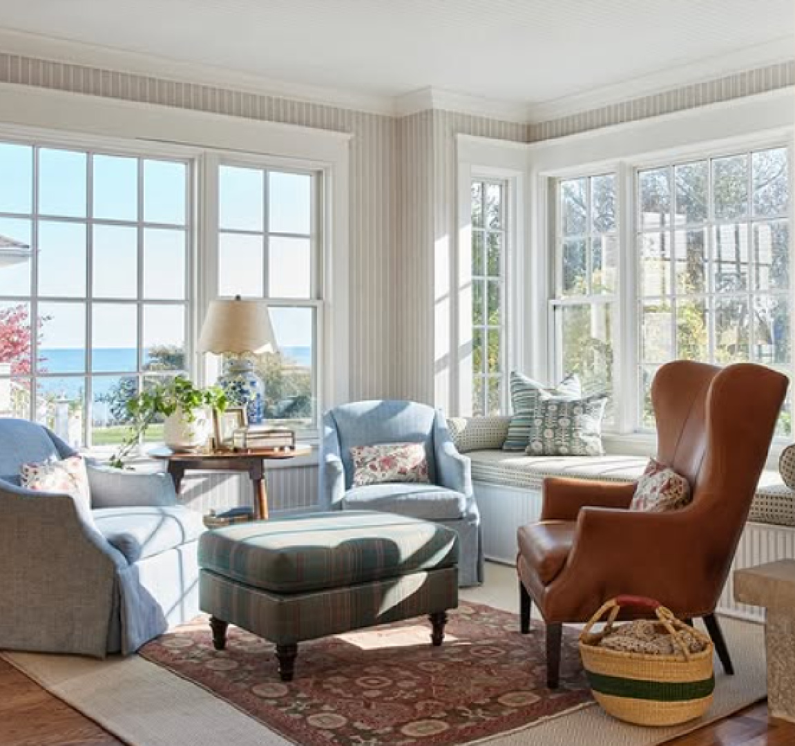 Light-filled coastal living room with wing chair - M+M Interior Design (photo: Heather Talbert).