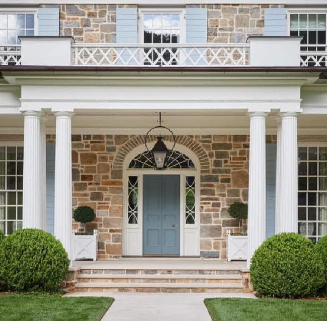 Spitzmiller and Norris house exterior with blue shutters, stone,, columns and classic architecture.