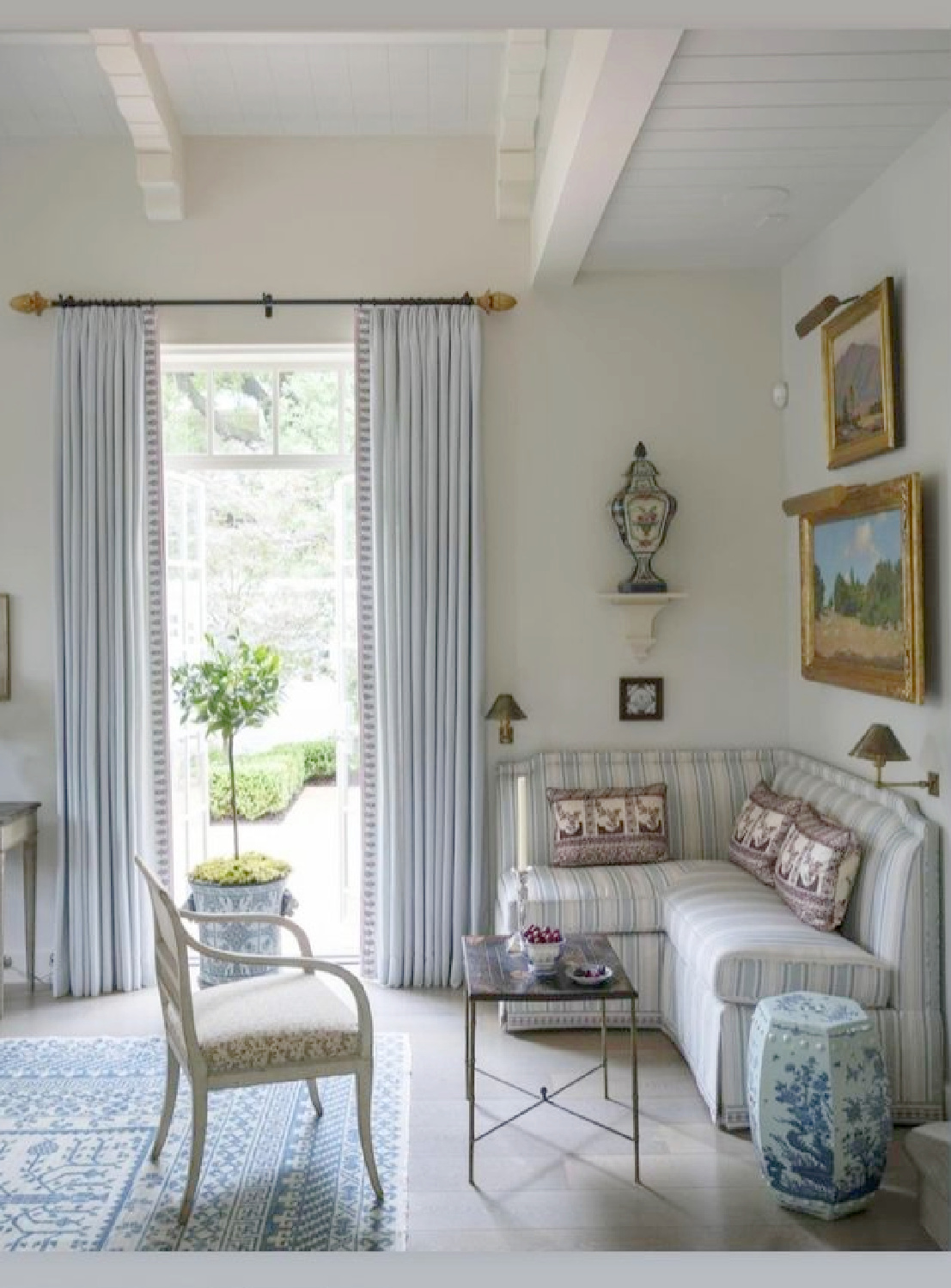 Blue banquette seating in elegant parlor by Cathy Kincaid Interiors.