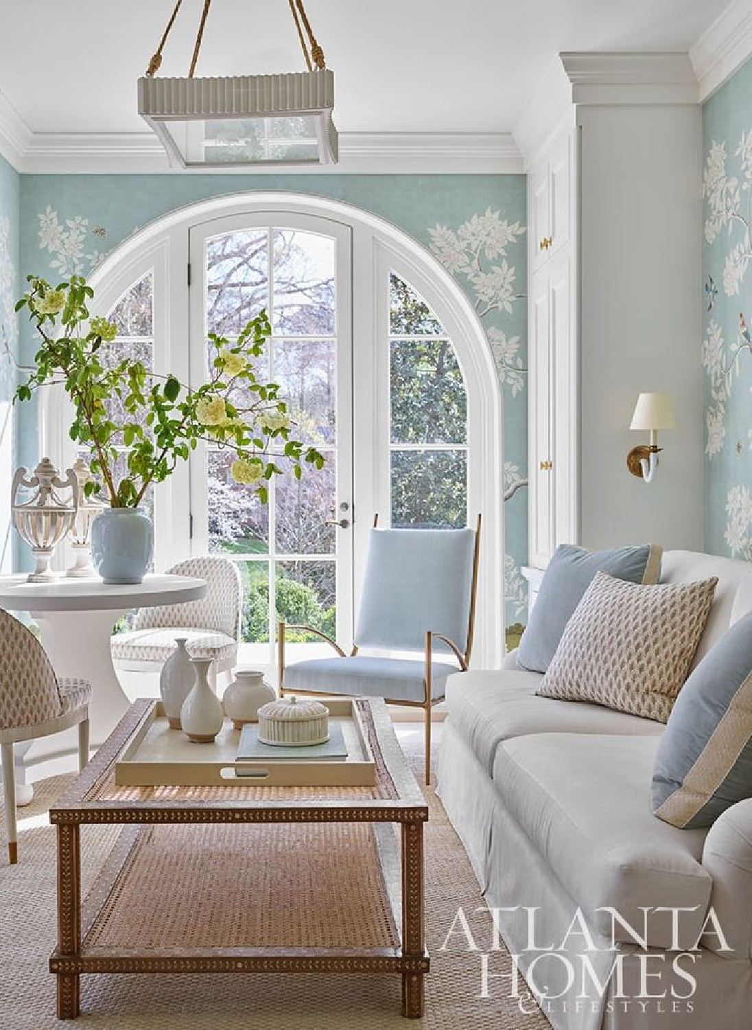 Lovely Limoges blue chinoiserie wallpaper (Gracie) in a living room with arch window - Atlanta Homes & Lifestyles.