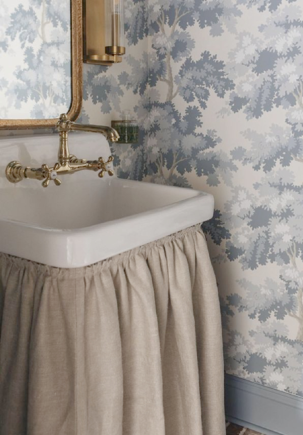 Raphael (blue) wallpaper in a lovely European country style bath with linen skirted sink - Plaster & Patina.