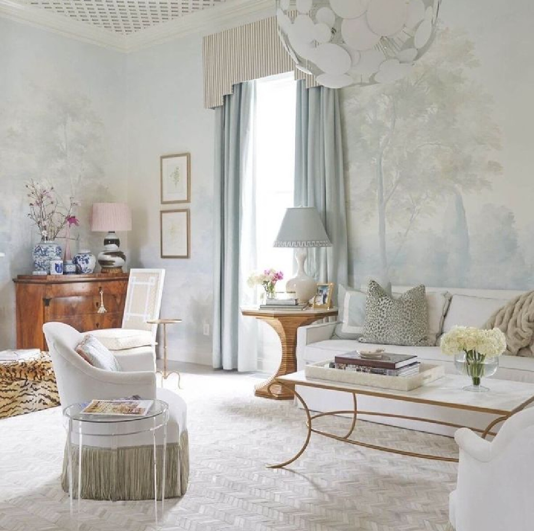 Serene and ethereal light blue accents and Susan Harter wallpaper mural in a living room by Rivers Spencer.