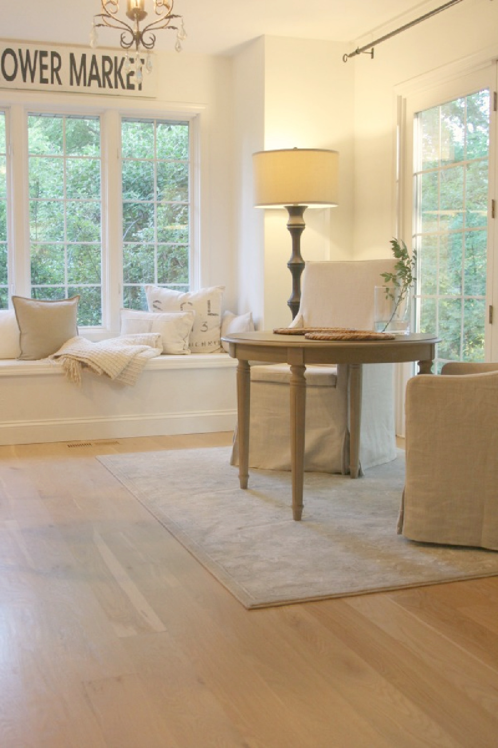Our breakfast nook with Belgian linen slipcovered chairs and floor lamp - Hello Lovely.