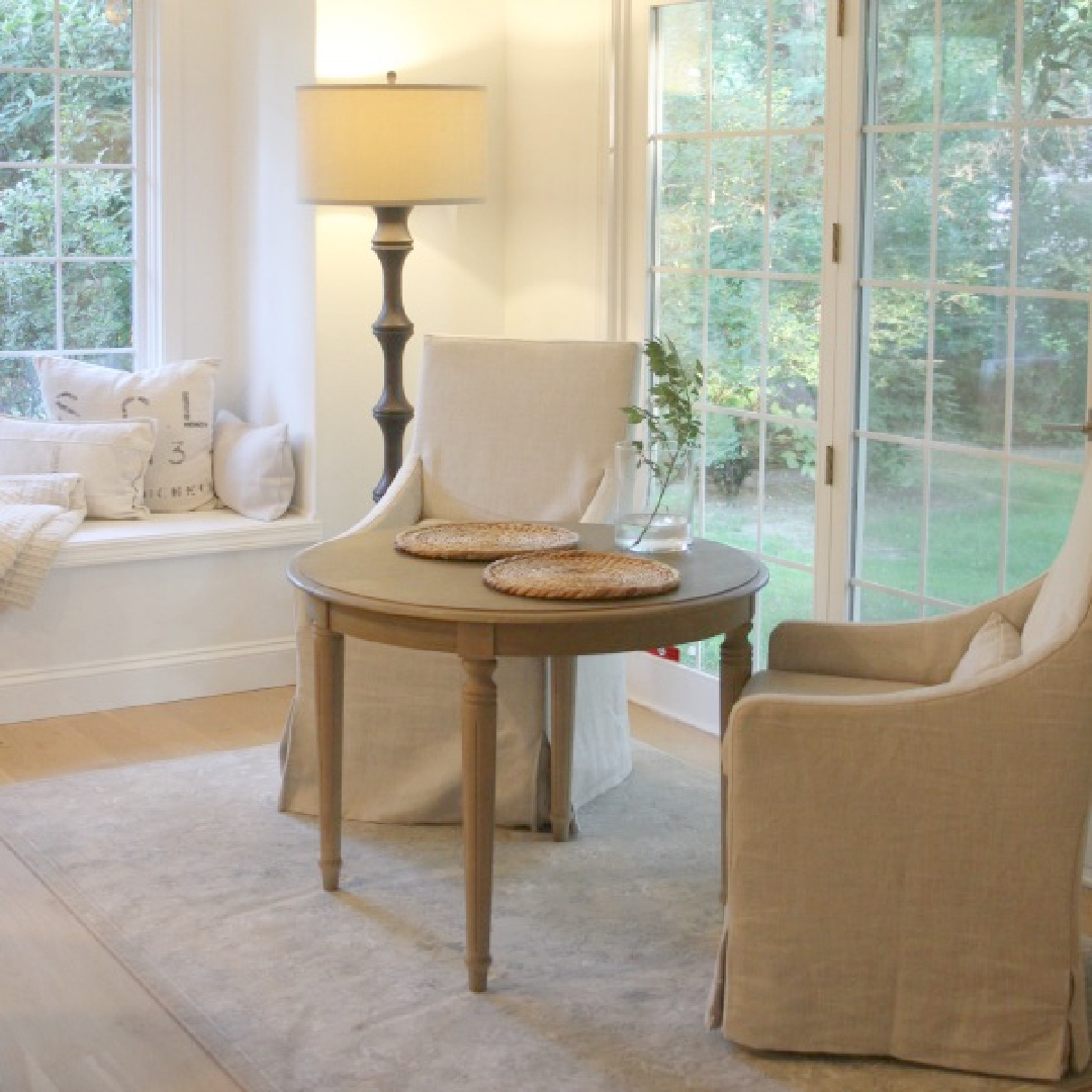 Our breakfast nook with Belgian linen slipcovered chairs and floor lamp - Hello Lovely.