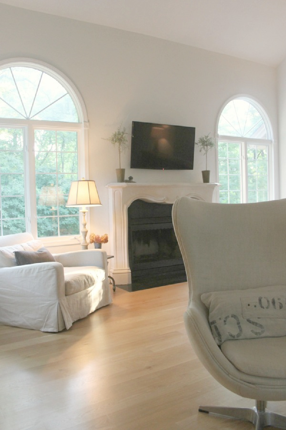 Hello Lovely's European country living room with Belgian linen slipcovered furniture and white oak.