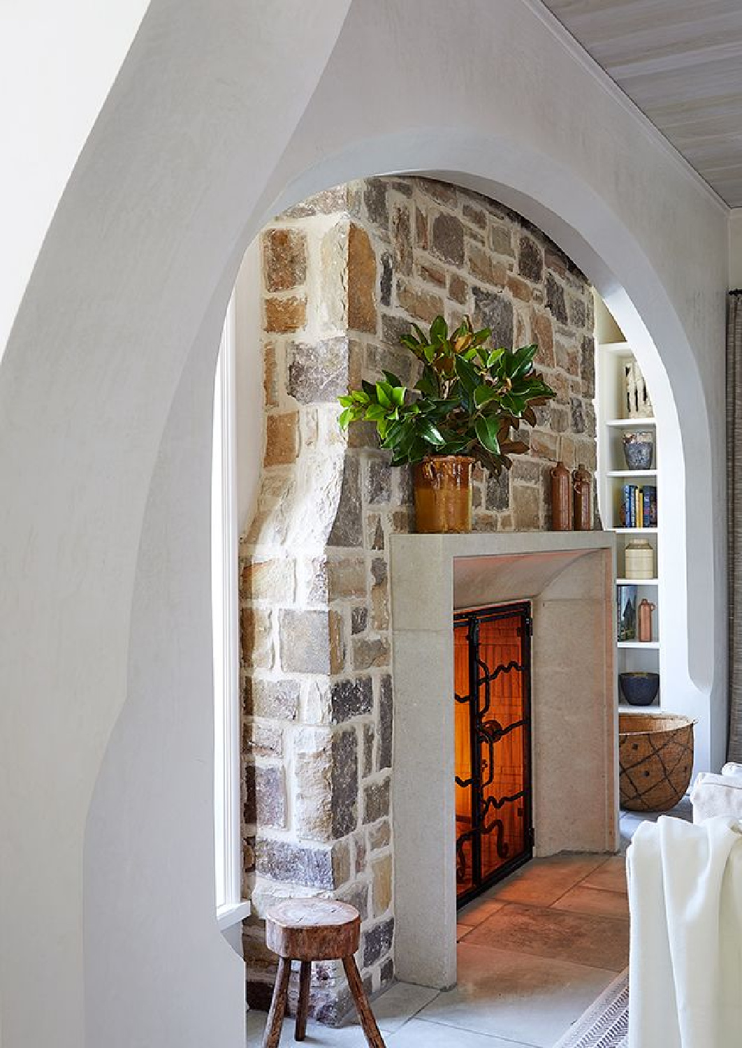 Beth Webb Interiors designed stone fireplace and arch. #rusticelegance #naturalstone #fireplacedesign