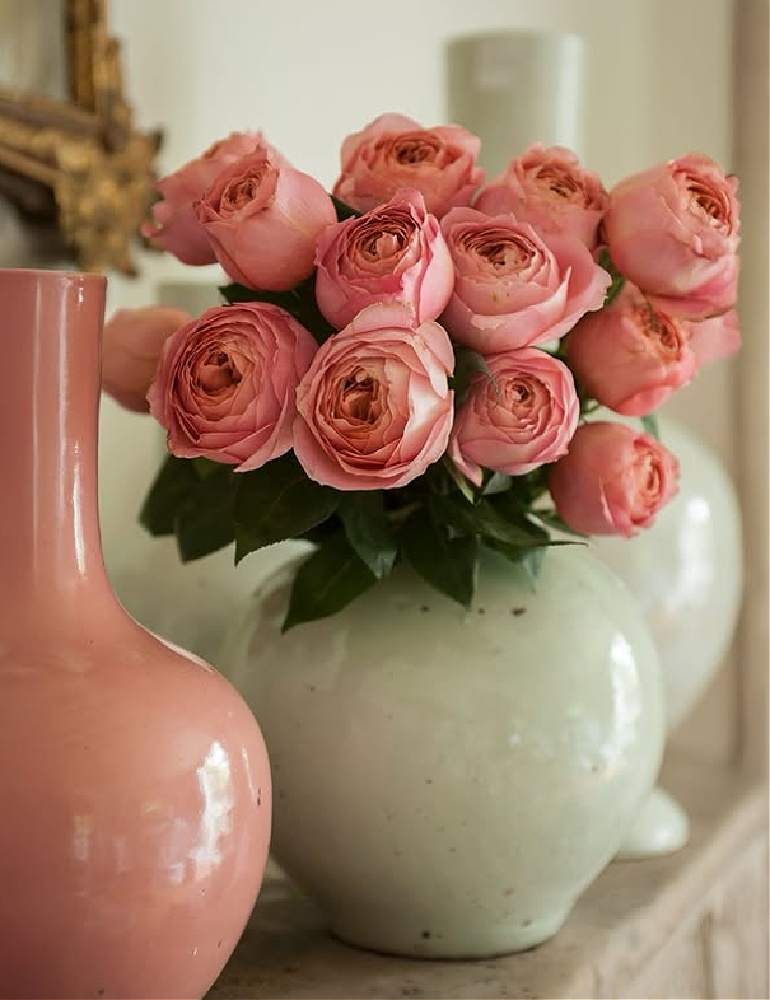 Shannon Bowers design - fireplace mantel with earthenware and pink blooms.