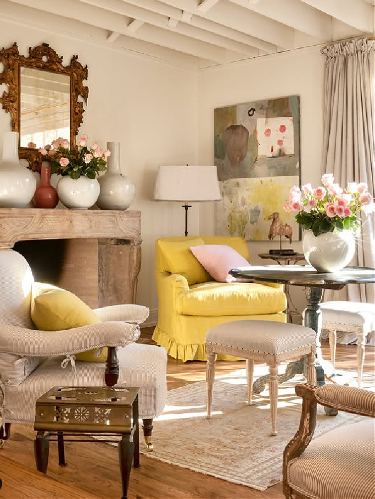 Shannon Bowers designed modern French living room with stone fireplace and pops of yellow.