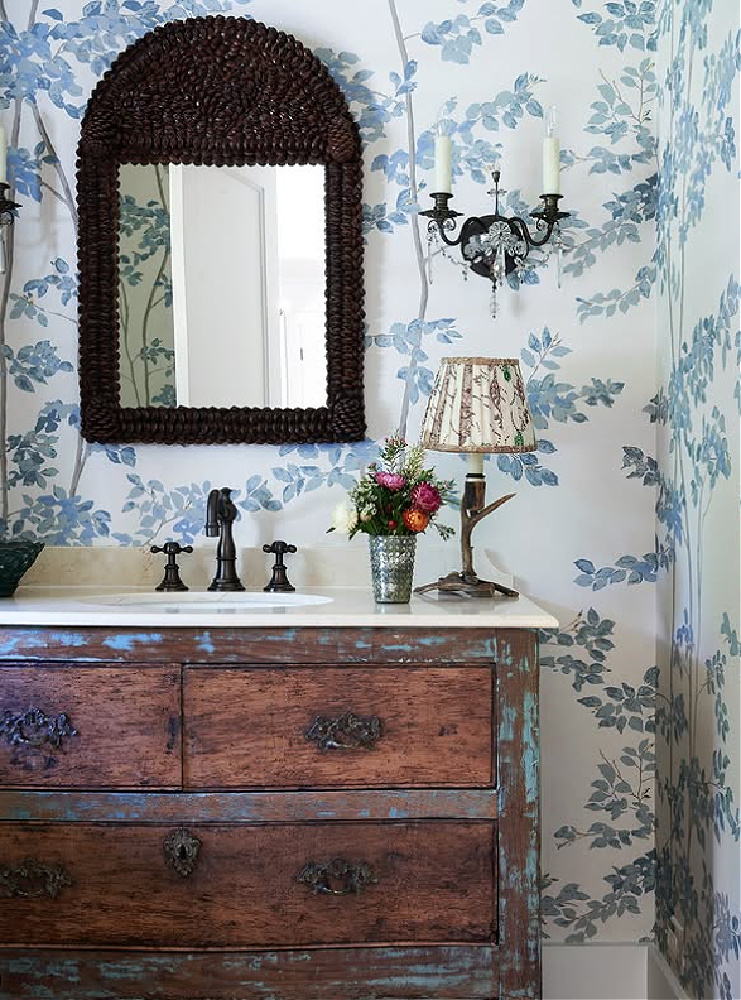 Shannon Bowers designed bath with lovely blue and white wallpaper and antique vanity.