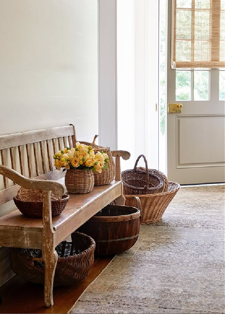 Baskets in a serene entry area with bench. Timeless interior design by Shannon Bowers with nods to European antiques, patina, understated elegance, and sophisticated simplicity. #shannonbowers #timelessinteriors