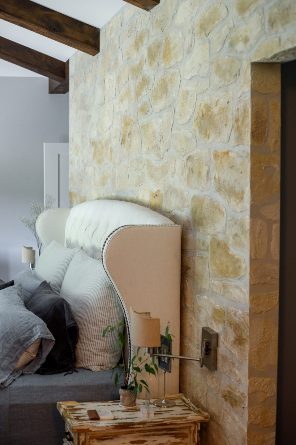 Rustic elegance in an Old World style bedroom with stone wall created with stencil kit from @thedetalles. #rusticelegance #stonewallstencil #fauxstone #thedetalles