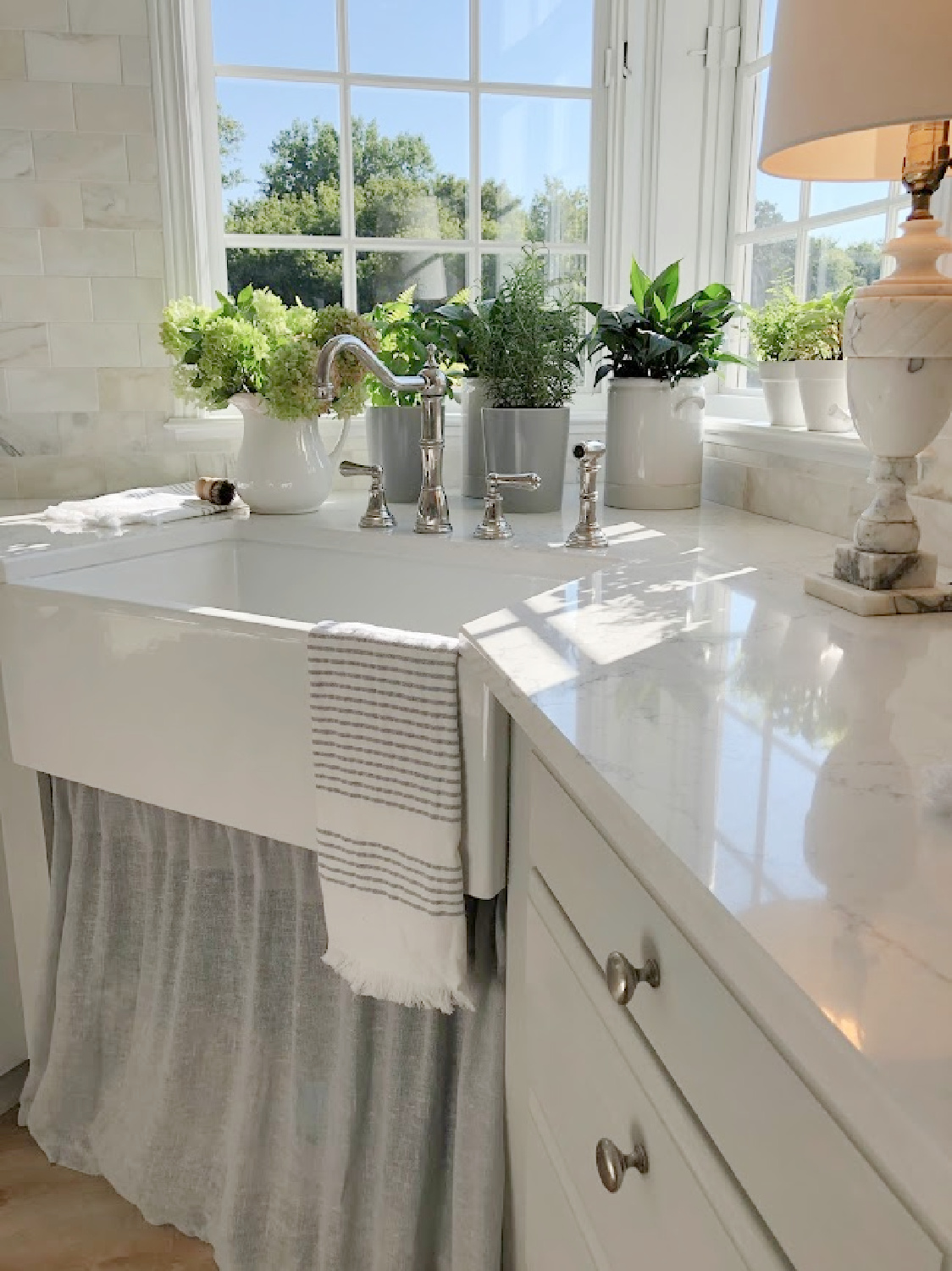 Hello Lovely's modern French kithcen with Muse quartz counters (VIATERA) and farm sink.