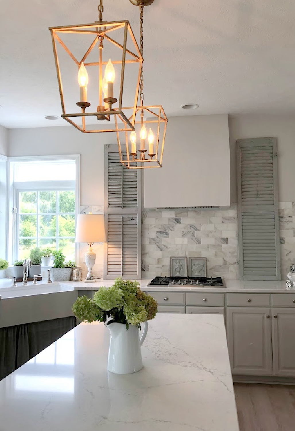Hello Lovely's modern French renovated kitchen with Dalarna lantern pendants over island (Muse Viatera white quartz).