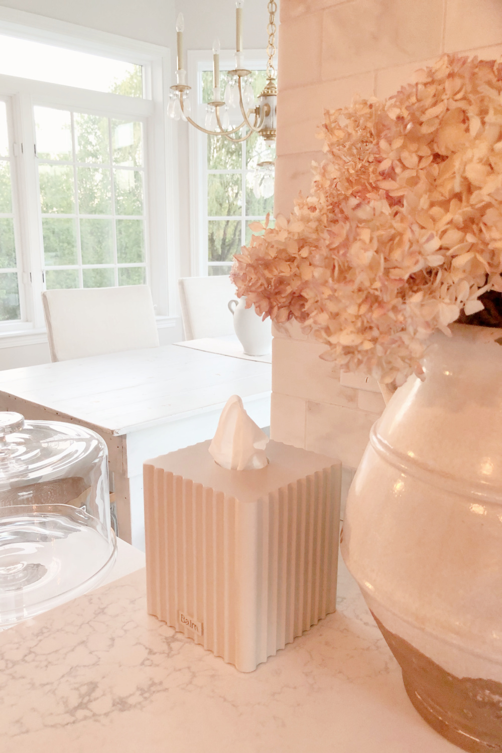 Hello Lovely's European country kitchen with gilded chandelier, Muse quartz counters (Viatera) and tissue box cover (The Balm Home).