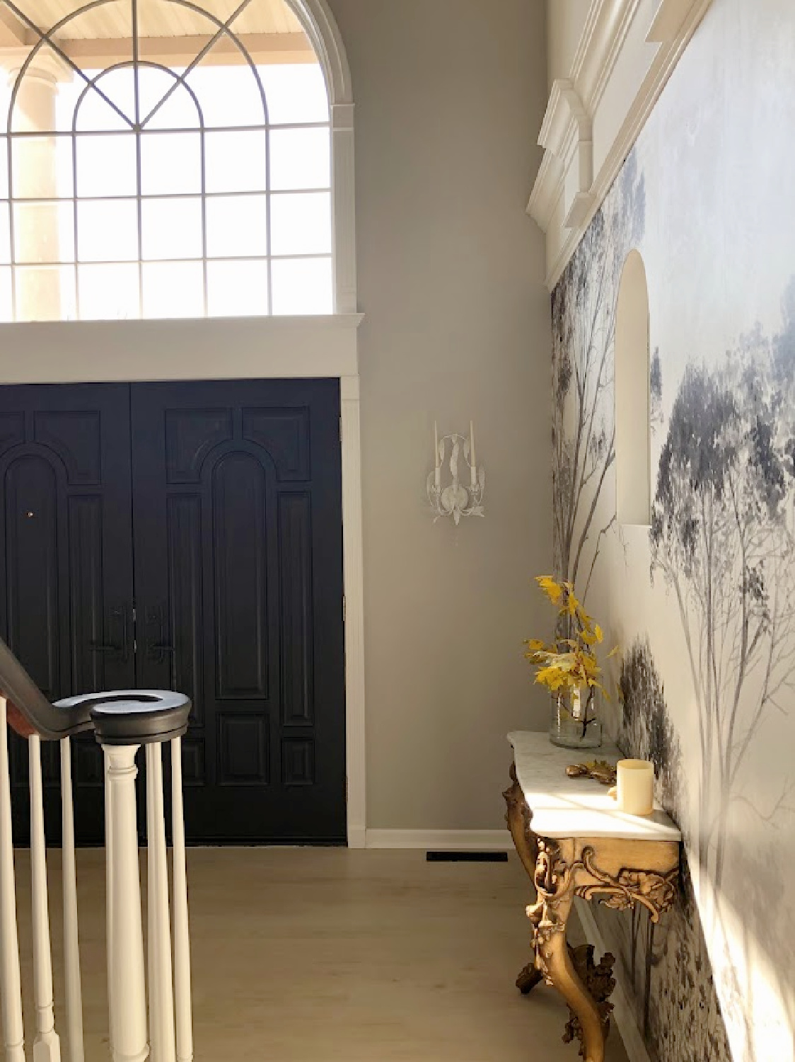 Hello Lovely's entry hall with antique French console table and mural wallpaper.