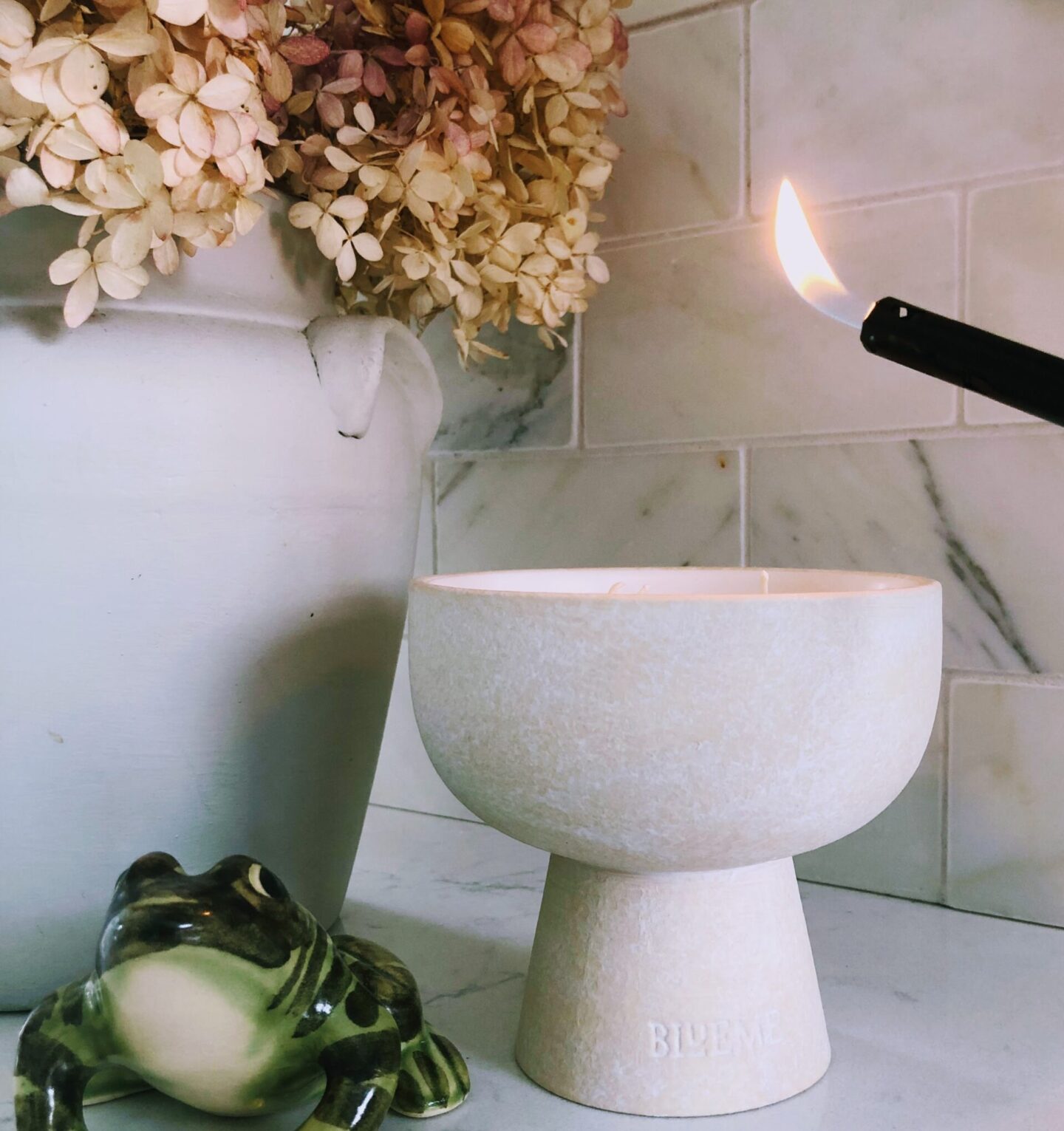 Hello Lovely's DIY renovated modern French kitchen with Viatera Muse quartz counters, calacatta marble backsplash, and Blueme candle (Calm).
