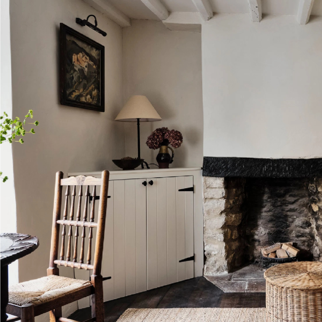 Rustic fireplace and builtins in a Cotswolds stone cottage. Called Armada Cottage dates to 1489 with reimagined interiors by Beth Dadswell (Imperfect Interiors).