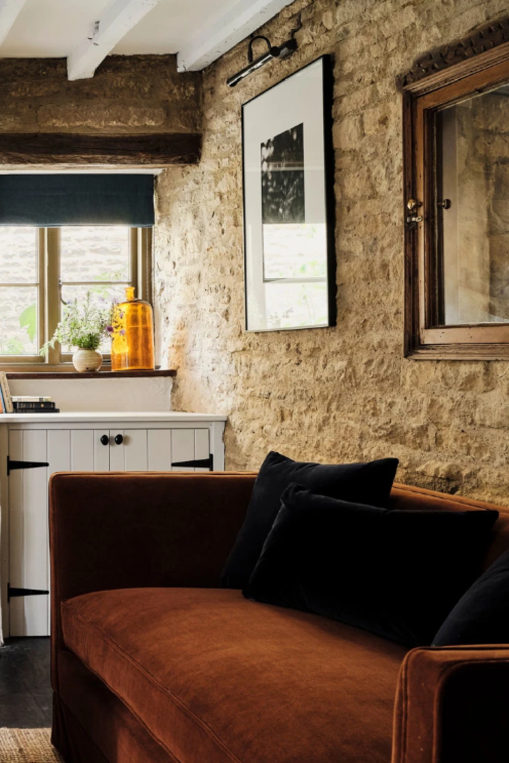 Rustic wall in a Cotswolds stone cottage. Armada Cottage dates to 1489 with reimagined interiors by Beth Dadswell (Imperfect Interiors).