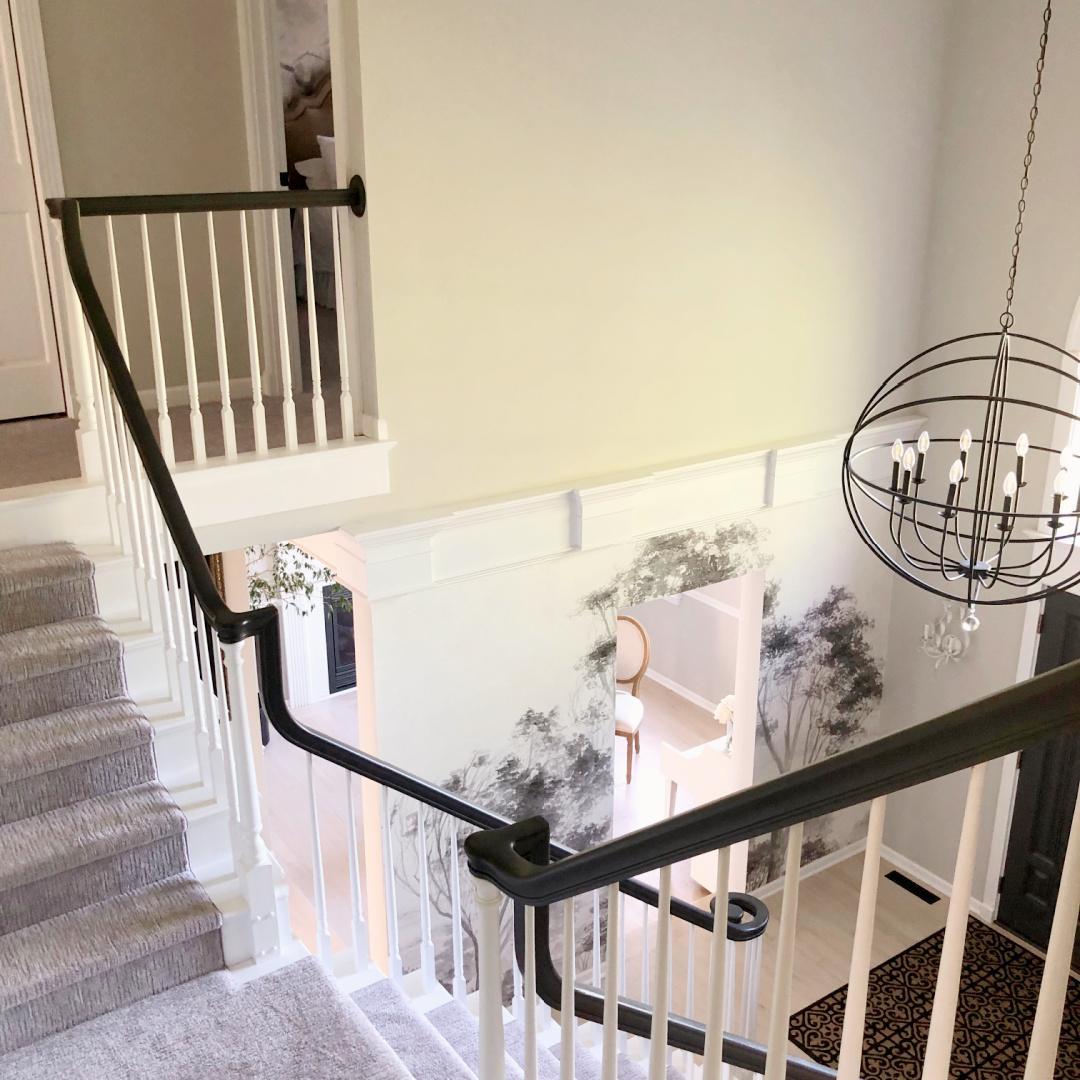 SW Repose Gray in Hello Lovely's two story foyer with mural wallpaper, modern orb chandelier and Farrow & Ball Railings painted front doors.
