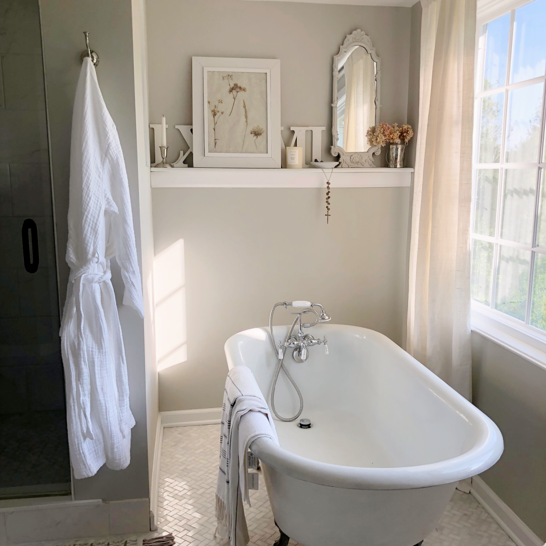 Hello Lovely's bath painted SW Repose Gray with clawfoot tub and shelf with framed botanical print made by Michele.