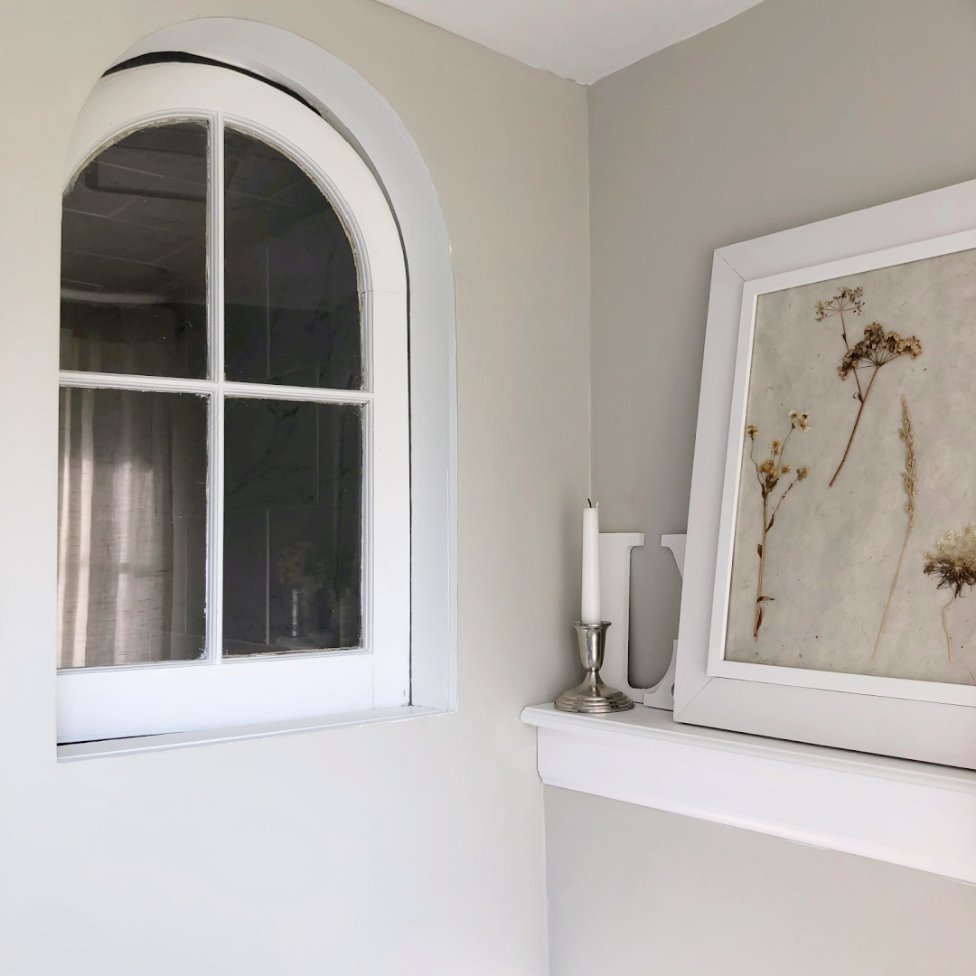 Hello Lovely's DIY renovated bath with SW Repose Gray walls and salvaged arched window in shower.