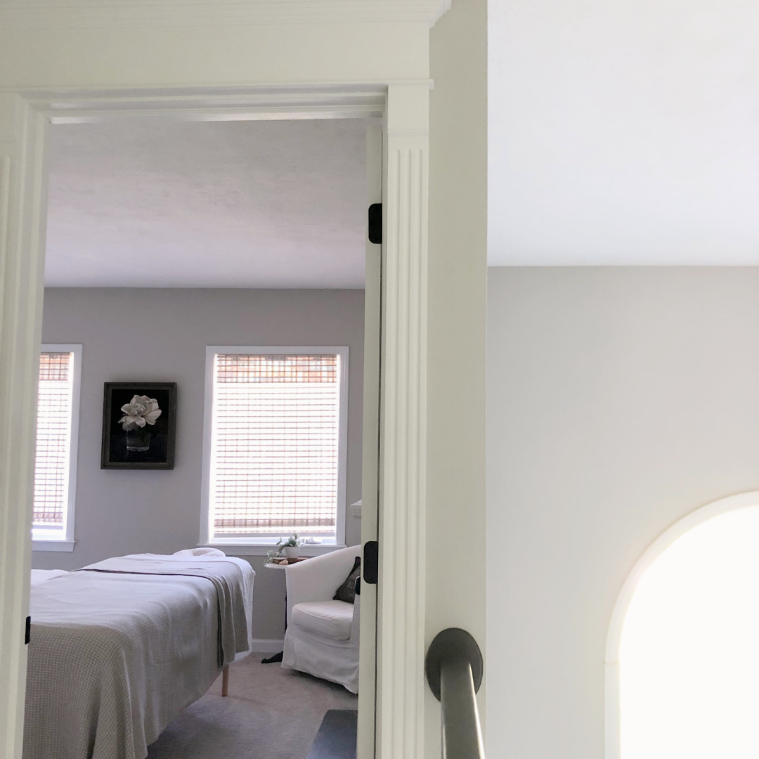 Hello Lovely's guest bedroom with SW Agreeable Gray and massage table.
