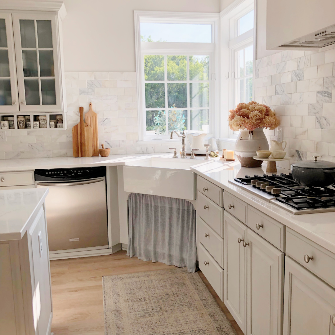 Hello Lovely's modernn French kitchen with F&B Pavilion Gray on cabinets, farm sink, and calacatta marble.