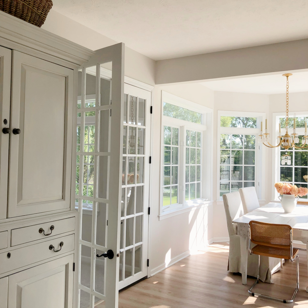 Hello Lovely's DIY renovated kitchen with French doors to family room and sun room breakfast area.