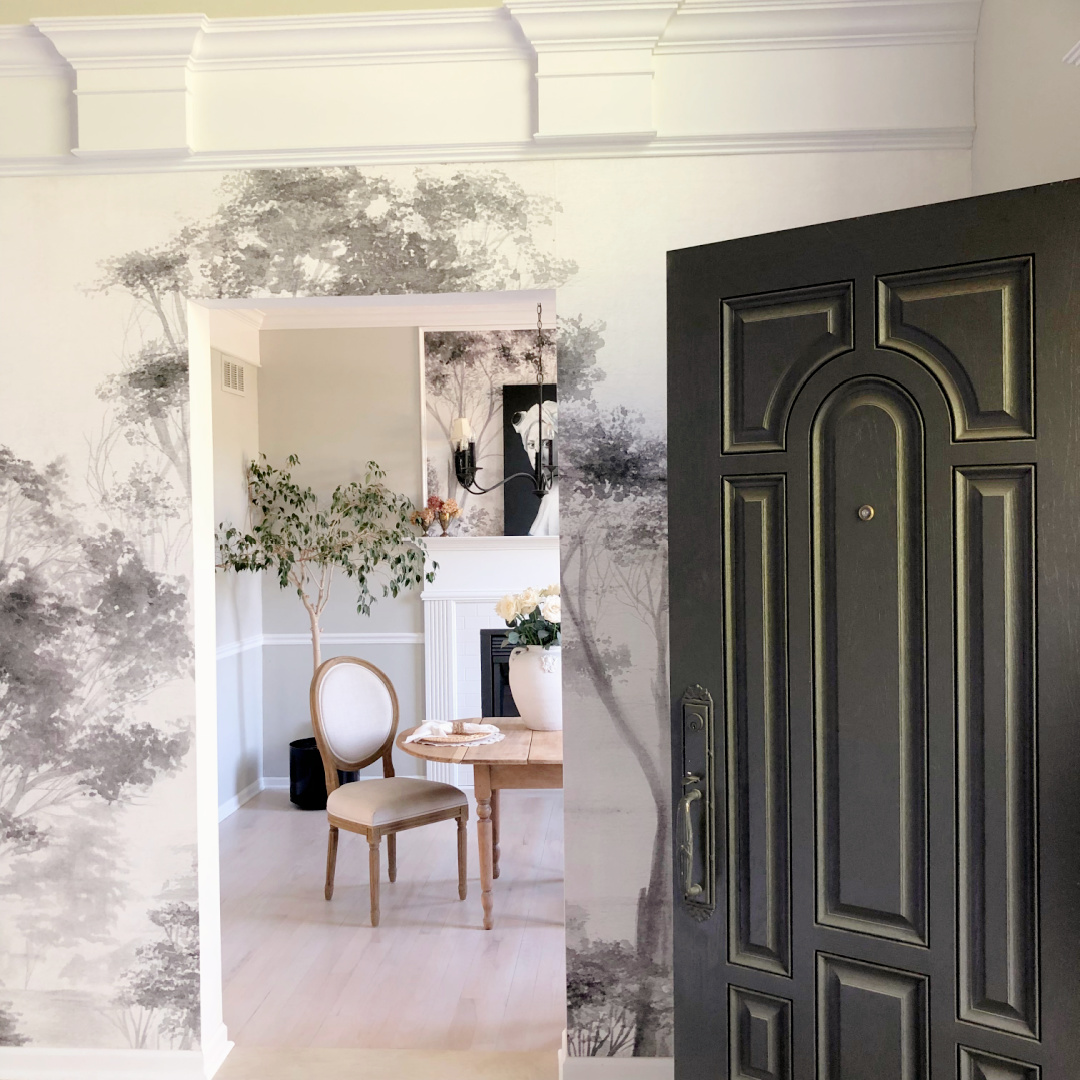 Hello Lovely's DIY renovated dining room off the entry with custom wallpaper grisaille mural.