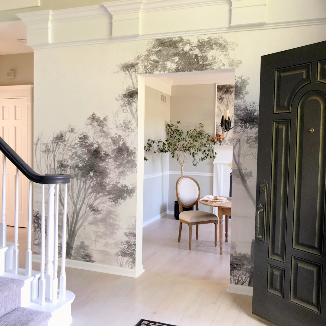 Hello Lovely's DIY renovated dining room off the entry with custom wallpaper grisaille mural.