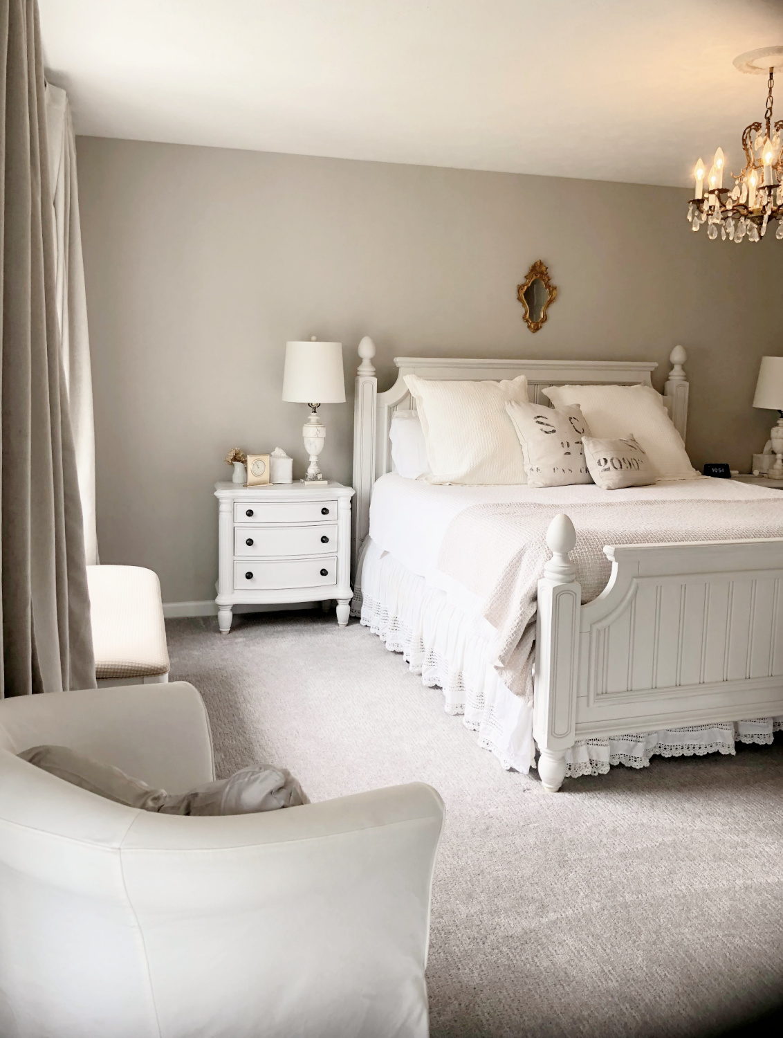 Hello Lovely's bedroom with coastal beadboard furniture, vintage chandelier and greige walls painted Sherwin-Williams Agreeable Gray.