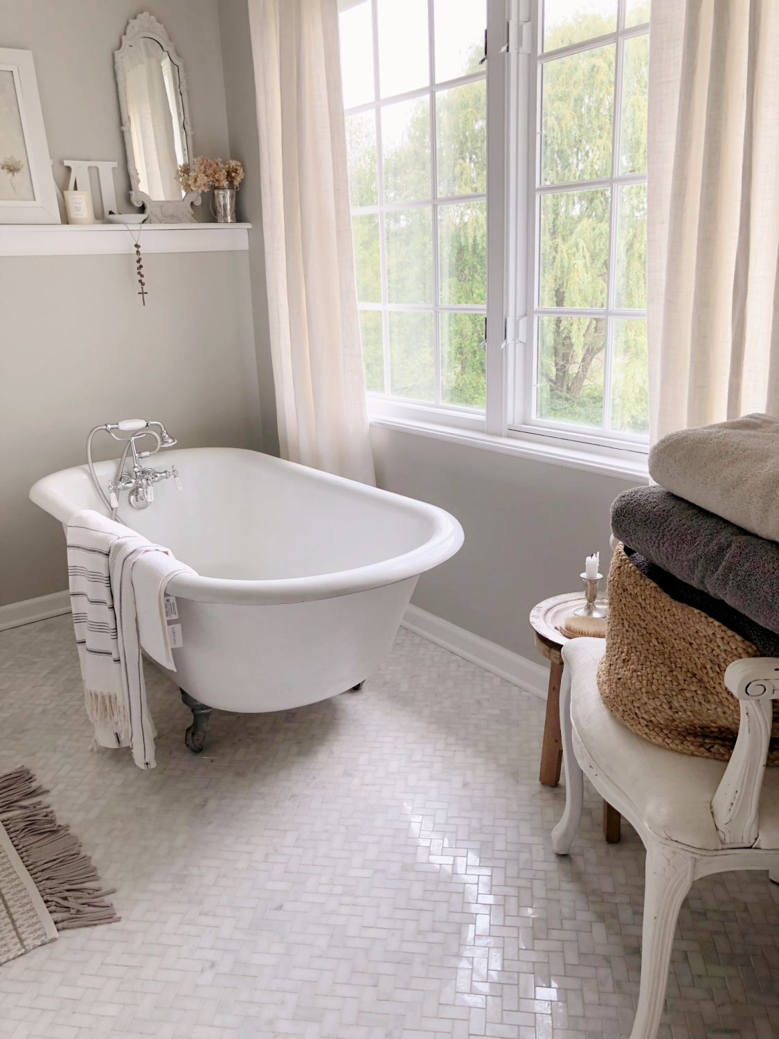Hello Lovely's serene bathroom painted SW Repose Gray with clawfoot tub and botanical art created by Michele from wildflowers on her property.