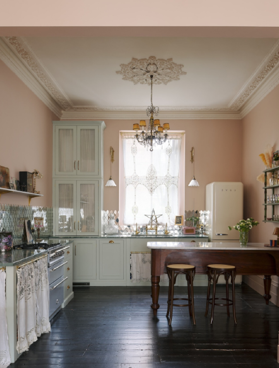 Pink walls in a magnificent English country unfitted Pearl Lowe kitchen by deVOL.