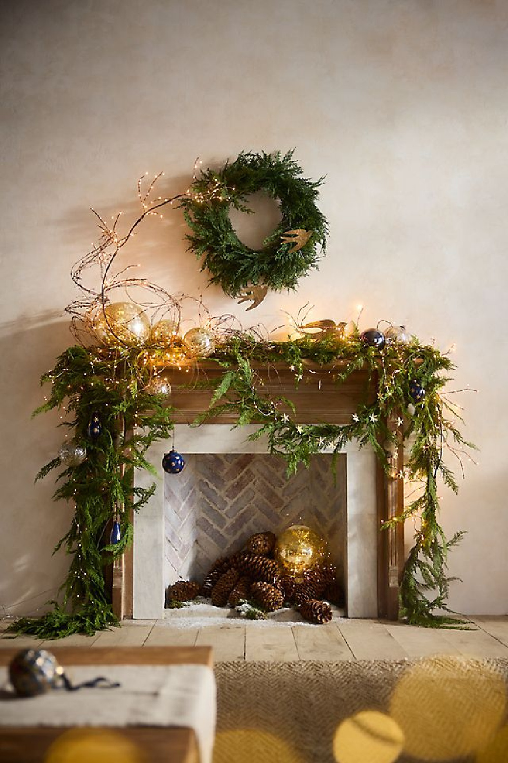 Terrain - French country style fireplace strung with garlands for the holidays. #holidaygarland