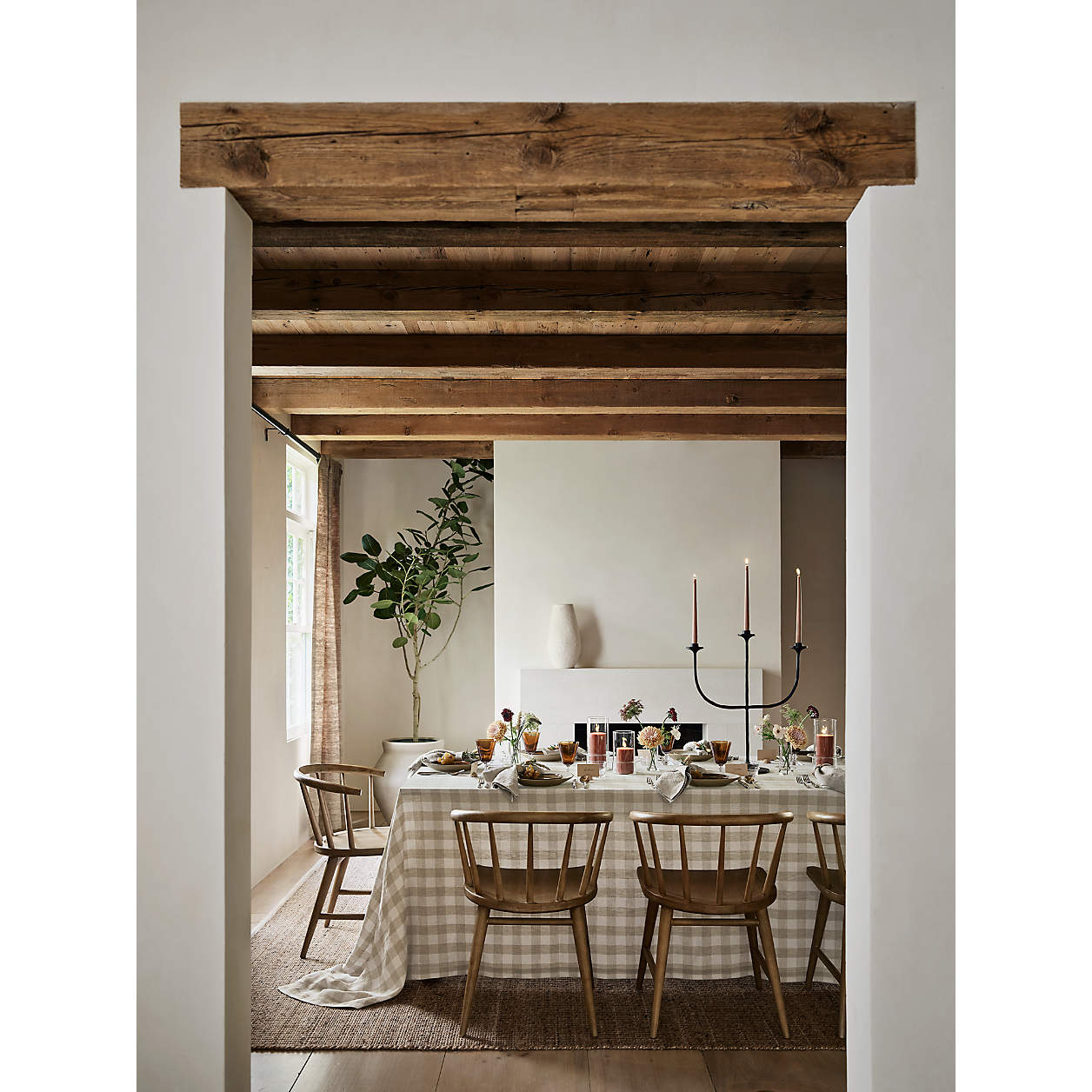 Crate and Barrel Metal Trident Candelabra on a charming Thanksgiving table with checkered tablecloth.