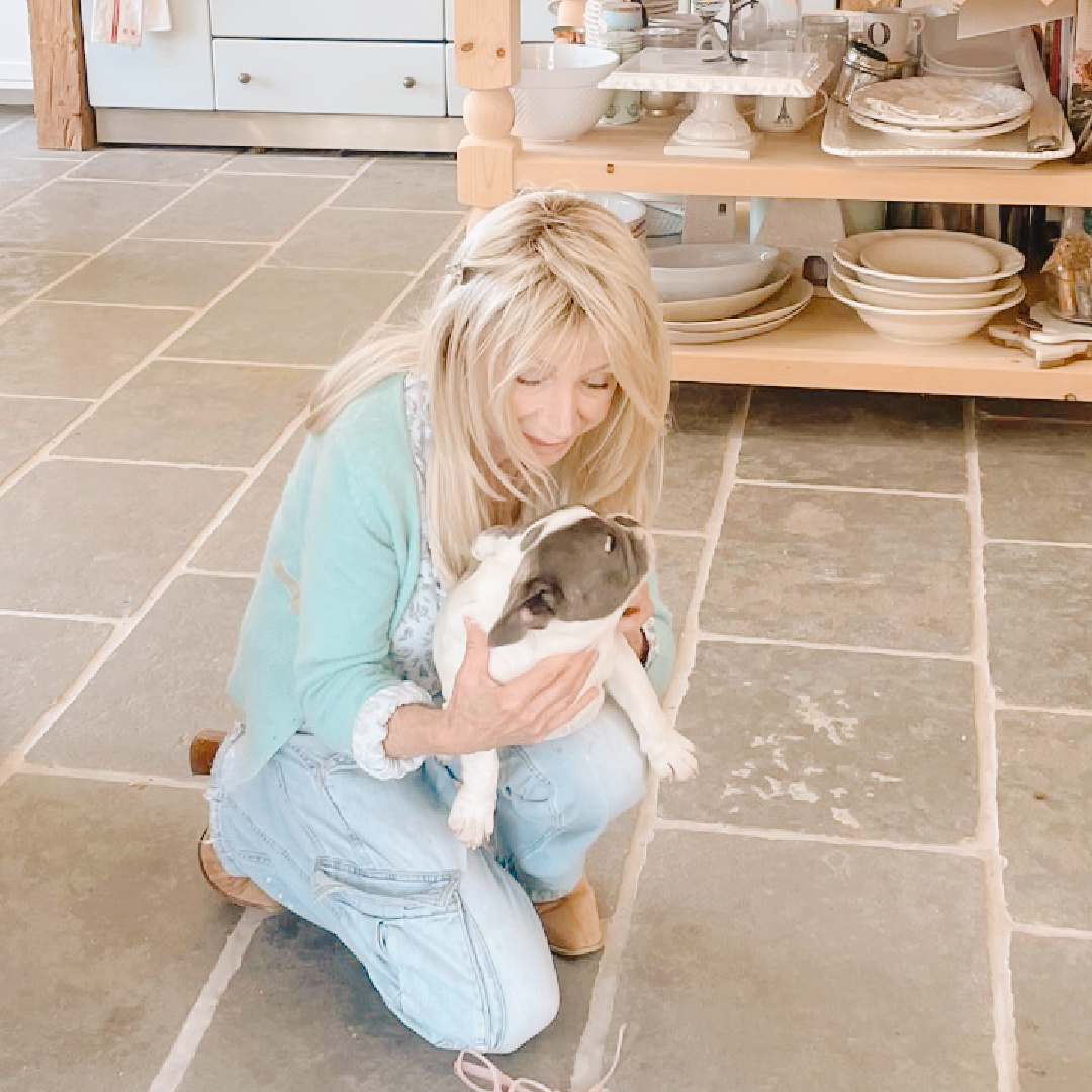 Animal activist Fifi O'Neill with a sweet pu in a beautiful French country kitchen.