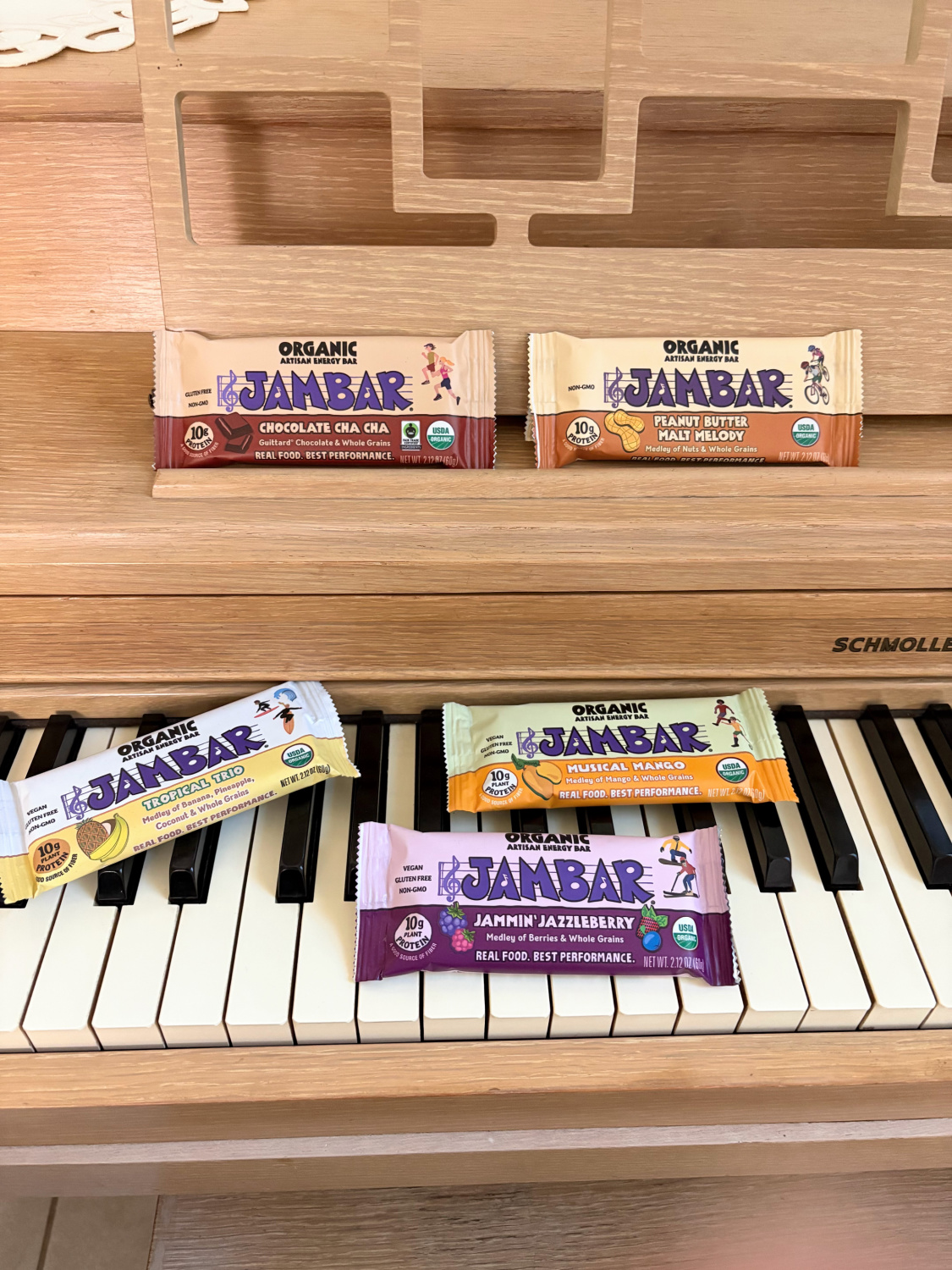 Assortment of Jambar organic artisan energy bars (gluten free!) on my MCM piano - Hello Lovely Studio.