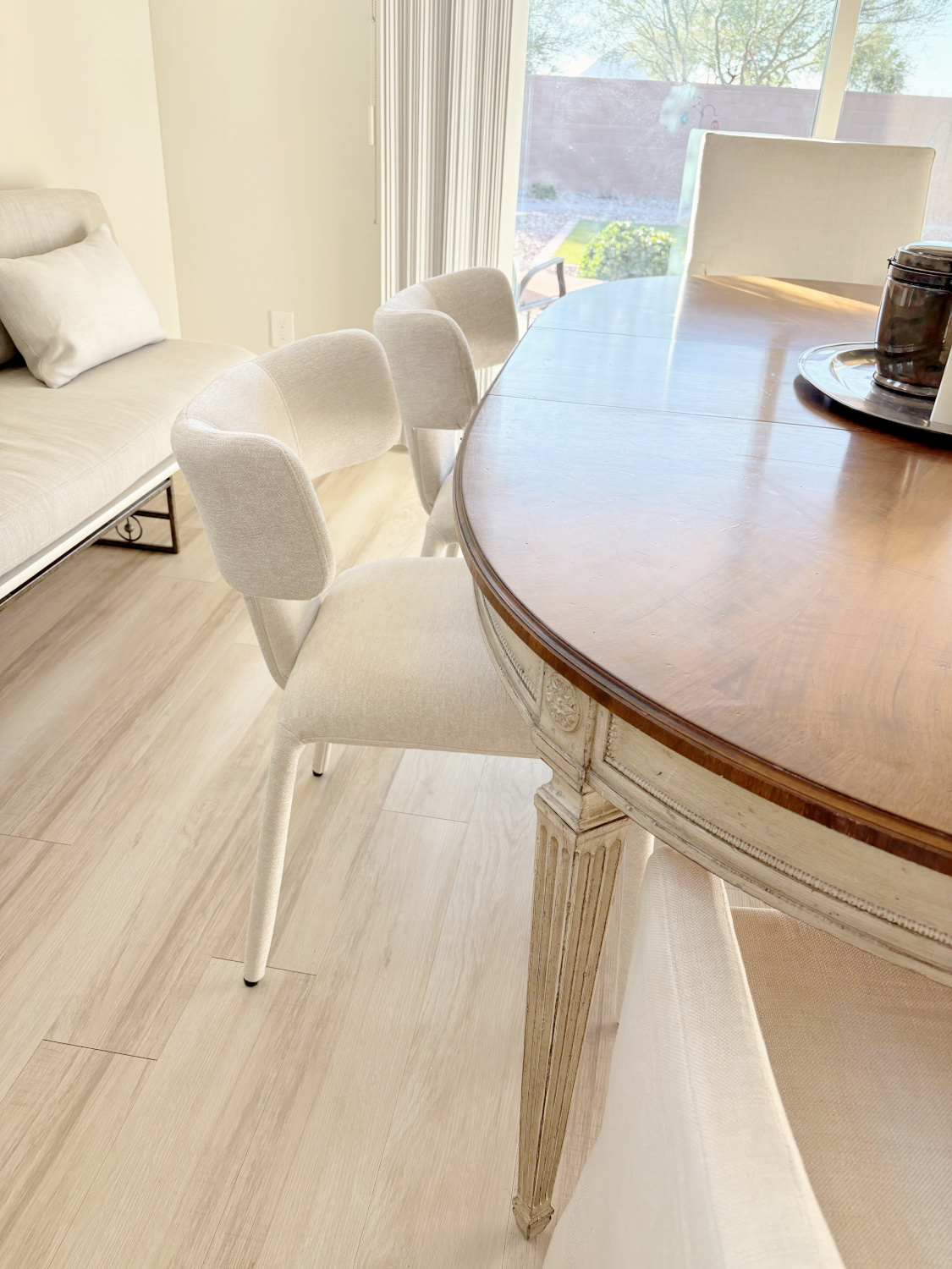 Modern Scandi style upholstered ivory dining chairs from Wayfair at my dining table - Hello Lovely Studio.