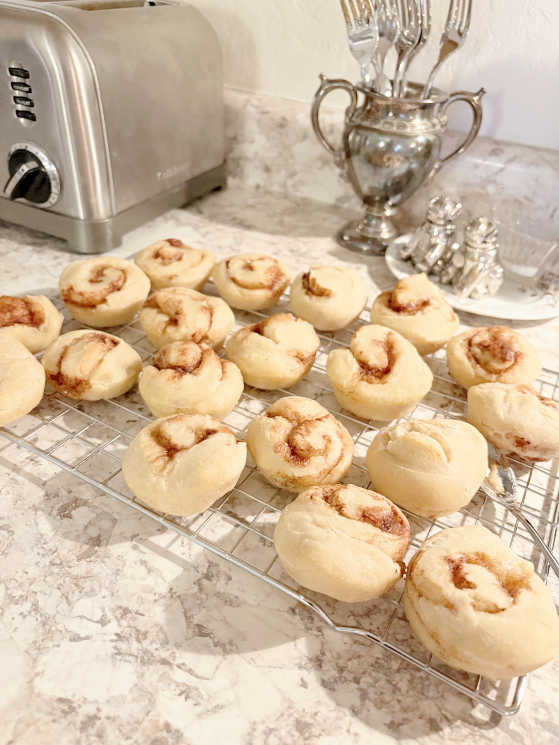 My sourdough cinnamon rolls cooling on the counter - Hello Lovely Studio.