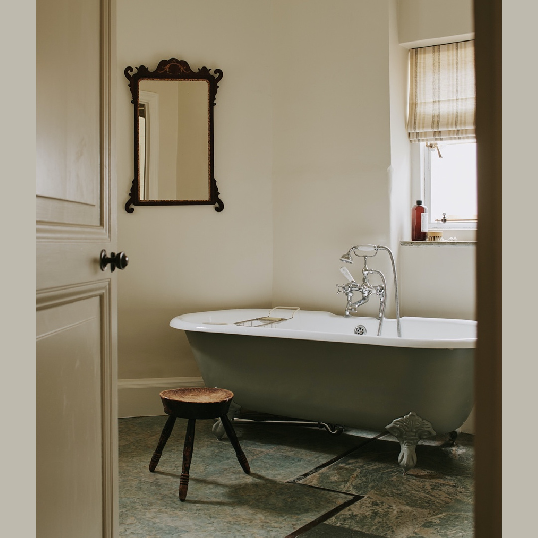 Beautiful cozy timeless English country exquisite minimal bath with clawfoot tub and antique mirror - design by Tamsin Saunders (HomeAndFound). #timelessinteriors
