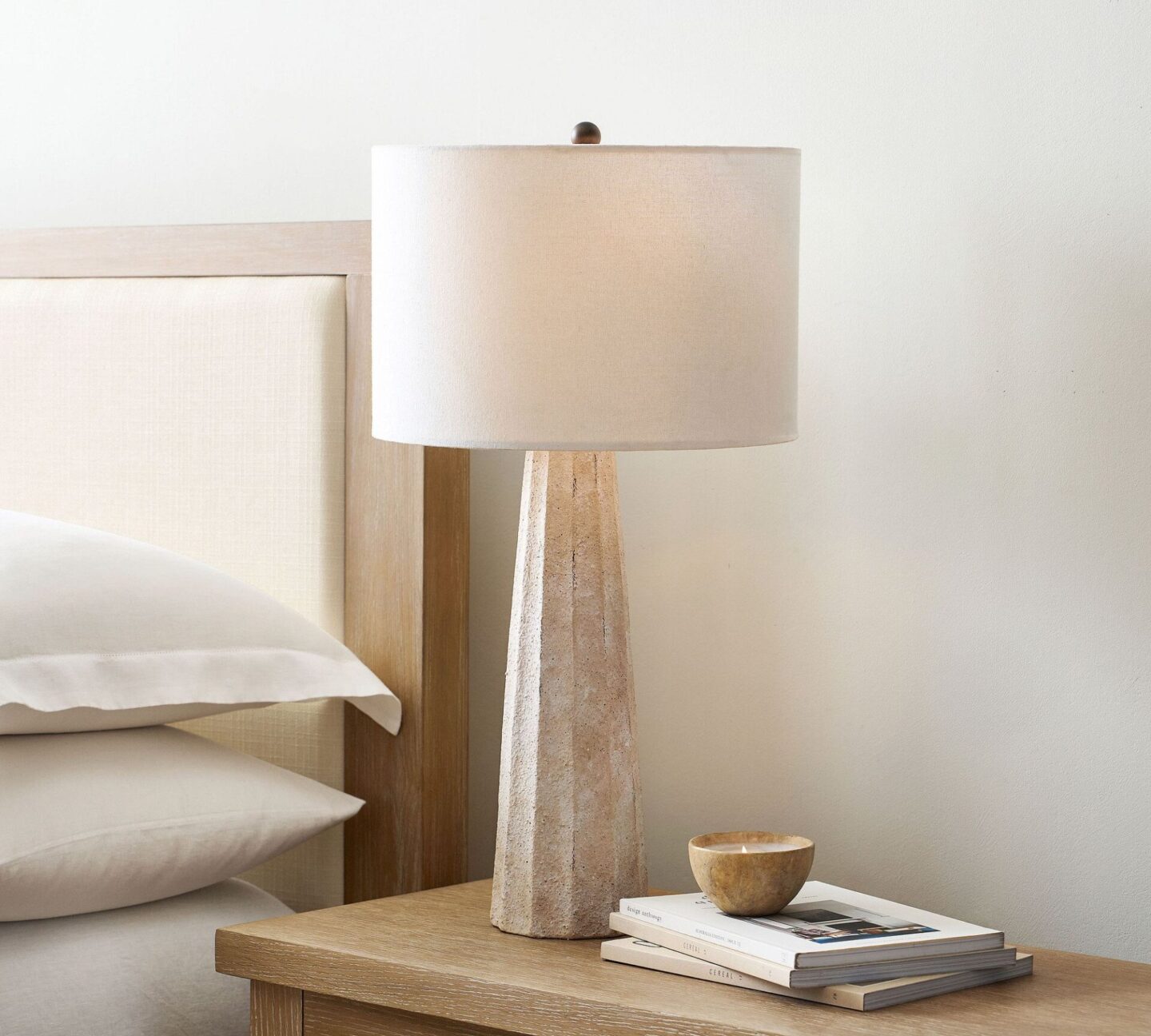 Anders Ceramic Tall Table Lamp in a serene natural bedroom with natural light wood tones, Pottery Barn.